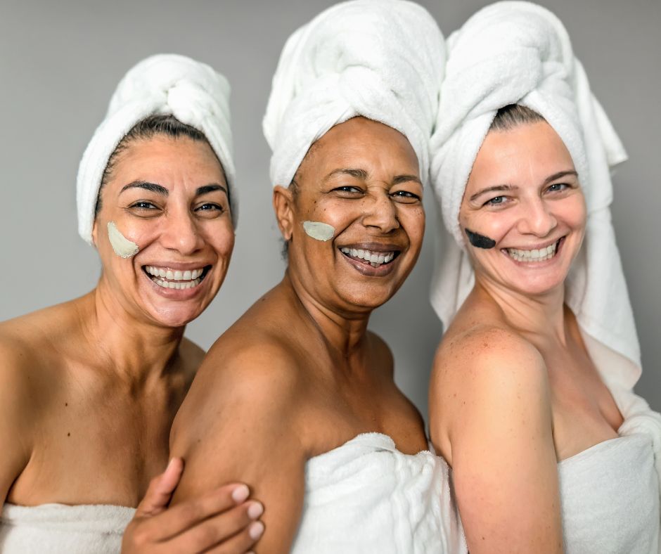 three women of different ages in robes with spa treatments